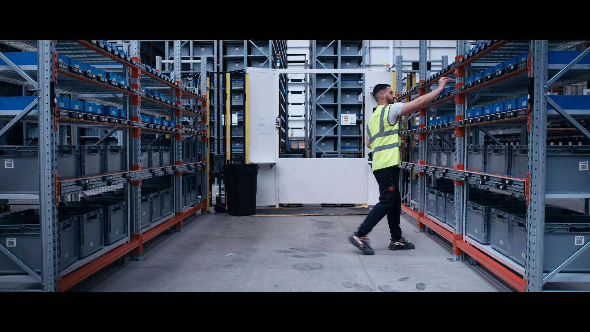 Warehouse worker putting items into put-to-light wall