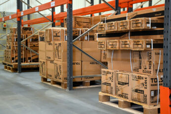 Palletised cardboard boxes in ground level racking bay