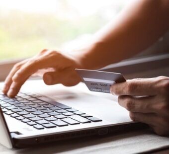 Laptop user entering credit card details