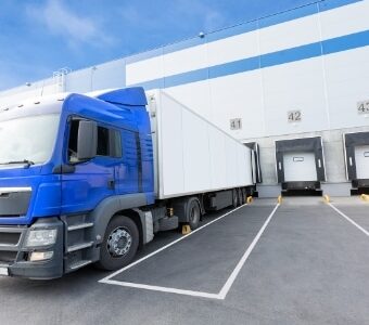 Lorry and trailer at warehouse loading bay