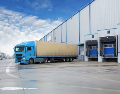 Blue lorry at warehouse loading bay