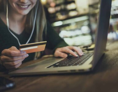 Woman at laptop entering card details