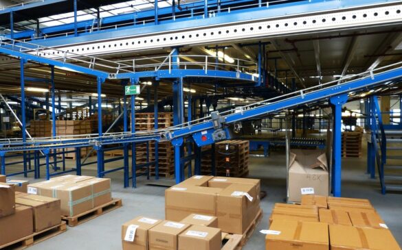 Automated conveyors between warehouse floor and mezzanine